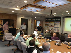 Charlie Paulette presents to members of the McLaughlin & Moran team as Derrick Ransford and Ed Mangine look on.