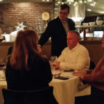 Brian Mitchell, Beverage Director, Max Restaurant Group, pouring wine selections.