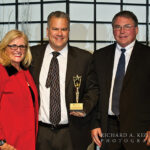 Rhode Island Speaker of the House Nicholas Mattiello receives the Governmental Hospitality Ambassador Award from Dale Venturini and Chairman of the Board H. Robert Bacon.