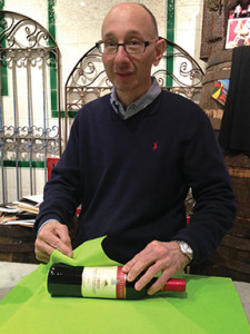 Fred Argilagos individually wrapping each bottle sold.