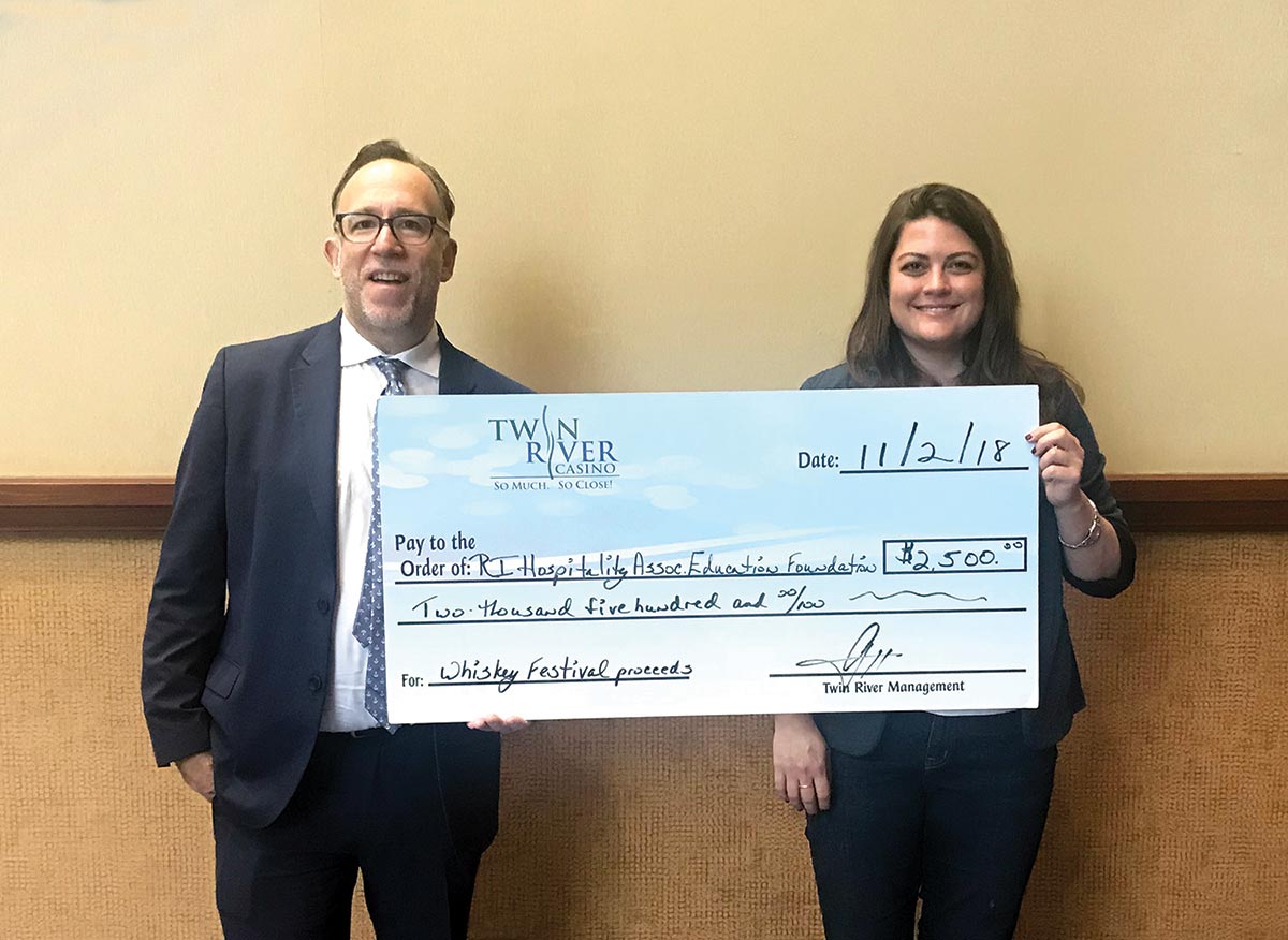 Annual Whiskey Festival Representative Presents Check to Event Beneficiary