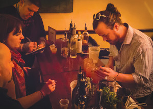 Leslie Martineau, Brand Ambassador, Merlet (center), and Judges Daveid Dadekian of Easke Drink RI (l) and Matt Jennings, Chef/Owner of Farmstead (r) watch Jonathan Dille, Executive Chef, The Grange, who took first place. 