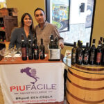 Owners Varsha and Prashant Mehta of Cork & Barrel in Hamden providing tastes of Piu Facile wines. 