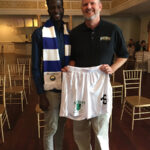 Omar Tall, University of Hartford soccer player and current CT United FC player with Richard Visco, CEO, Shebeen Brewing Company, showing off the Shebeen Brewing logo on the CT United uniform.