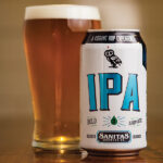 The American IPA is gold in color with ripe pineapple and “dank grassy hop undertones followed by bold bitterness.”