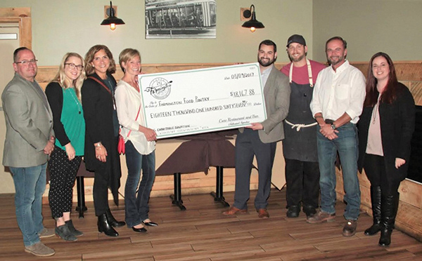 Cure Restaurant Presents Check to Farmington Food Bank