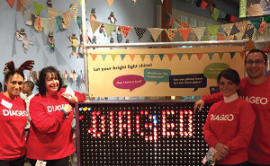 Diageo employees pose with the giant Lite-Brite™ exhibit at the Stepping Stones Museum for Children in Norwalk. Over 100 Diageo volunteers worked directly with groups of underprivileged children during the holiday party.