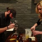 Conrad Meurice and Emily Blewett of Elm City Social preparing their cocktail.