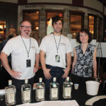 Ed Dunn, Account Development Manager, Brescome Barton; Dave Rudman, Director of Education and Account Development, Brescome Barton; and Beth Rose, Administrative Assistant Sales Team, Brescome Barton showcasing Farmer’s Organic Gin.