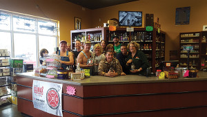 Tim Smith, center, visits with the staff of Big Gary’s Montville Wine and Spirits in Montville.