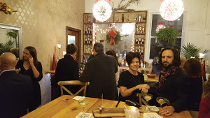 Guests enjoying Wild Moon Liqueur cocktails before the holiday dinner.