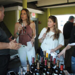 Sal Spenn, Shannon Ridge Vineyards speaking with Kaila Maurer, Sarah Smith and Courtney Eslin, all from Court House Bar and Grill in Putnam.