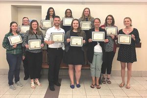 Mia Ginter (second in back from left) and Danielle Mason (back row, first on left) both of Brescome Barton, surrounded by fellow graduates in the Human Resource Certification program at CCSU.