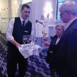 Tom Trelski of Hotel Viking, welcoming guests to the Grand Opening Reception with a glass of champagne.