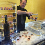 Bartender Anthony DeSerio hand carving ice for the cocktails.