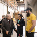 Former Narragansett Brewing Company employee Joseph Ianaire, who worked at the company for 34 years, next to Gov. Gina M. Raimondo during a tour of the Isle Brewers Guild facility in May. Isle Brewers Guild is now home to Narraganset Beer’s brewing operations.