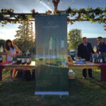 Sharon Alcocer, JC Imports; Carlos Figeroa, Owner, JC Imports; and Milton Monzon, Commercial Director, JC Imports, setting up a display table.