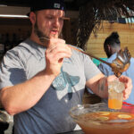 Dan Rek, Bar Manager, Elm City Social and event organizer for the competition, serving a welcome punch to guests. 