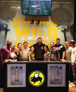 Jon Mason, Sales Representative, M.S. Walker (far left); Bill Dessel, Co-Owner, Keel Vodka (fourth from left); Matt Light, Co-Owner, Keel (center); with the team at Buffalo Wild Wings in Warwick along with Keel contest winners.