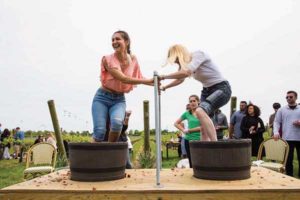 Guests at the Newport Vineyards Spring Celebration enjoy a grape stomping contest. 