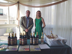 Mike Dudeff and Jillian Simms of Cellar Fine Wines prepare to pour Tuscan Sun Wines at May's Notre Dame High School  fundraiser. 