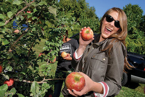 Onyx Moonshine Marketing Director Rachael Forker and (in the background) Eryka Wright, Production Manager, were part of the apple picking crew at Blue Hills Orchard in Wallingford. Photo by Nick Caito.