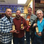 Four out of the six happy customers who won the raffle for a chance to purchase the elusive whiskies.