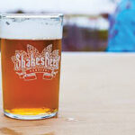 A festival pint glass with logo, designed by Serg Chernata.