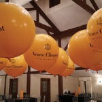 Bottles of Veuve Clicquot decorated the tables while branded balloons drew attention aloft during the New Year’s Eve celebration at Farmington Gardens.