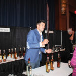 Noah King-Smith, Slocum & Sons, speaking with a guest about Don Abraham Tequila. 