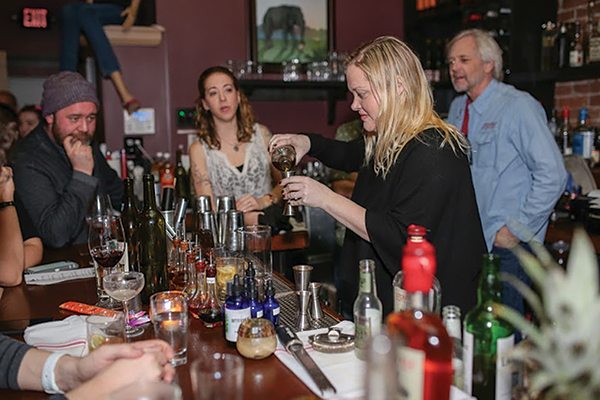 Markoja mixes her cocktail as Chris Parrott, Owner, Little River Restoratives, Christen LaRochelle of Slocum & Sons and Jack Baker, Co-owner, Litchfield Distillery, look on.