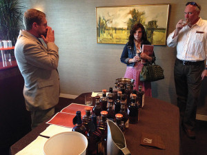 Dee Blackmer, Wine and Spirits Account Development Manager, Brescome Barton, a customer, and Chris MacKinnon, Sales Representative, Brescome Barton tasting in The Higher Marques Room of “Mashed: An Unprecedented Whisk(e)y Showcase,” held on June 2, 2014 at On20 Restaurant in Hartford.