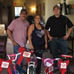 Project Broken Wheel volunteers delivering bikes to Adoption Rhode Island. Frank Martucci, General Manager of Beverage Operations, Twin River Casino; Alaina Bart, Volunteer, Project Broken Wheel; Paul Zagami, Volunteer, Project Broken Wheel.